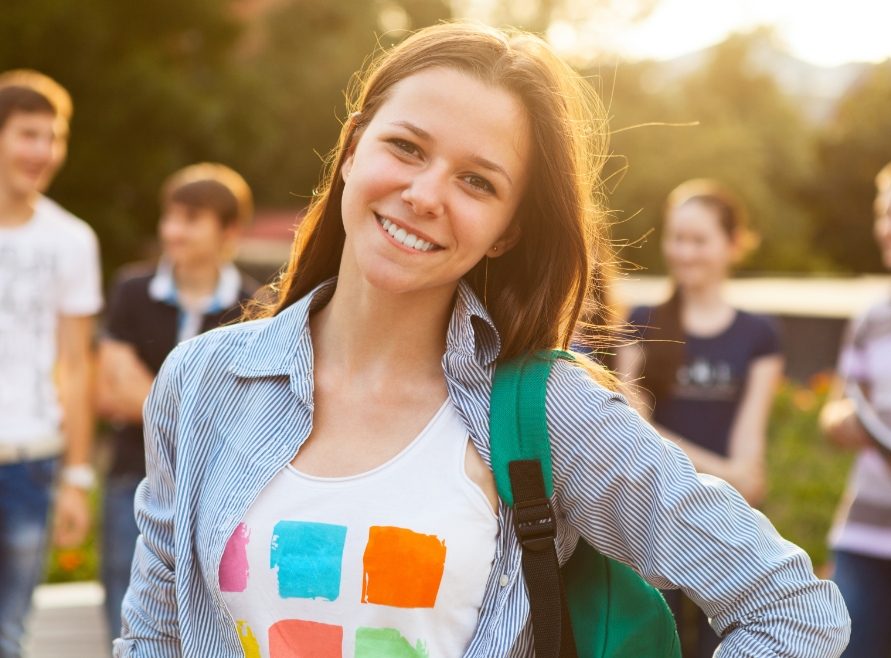 Teen girl with healthy smile after visiting the orthodontist and pediatric dentist