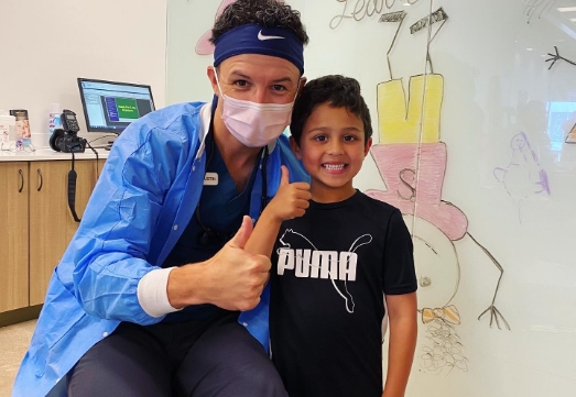 Doctor Welke and young patient giving thumbs up