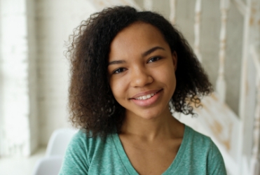 Young woman smiling after visiting the orthodontist