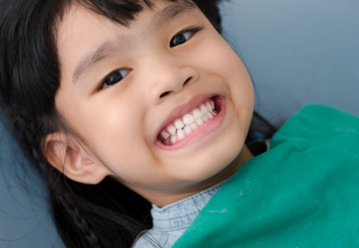 Child smiling during oral health risk assessment