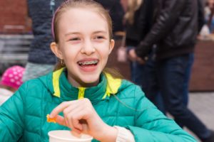 child eating lunch with braces