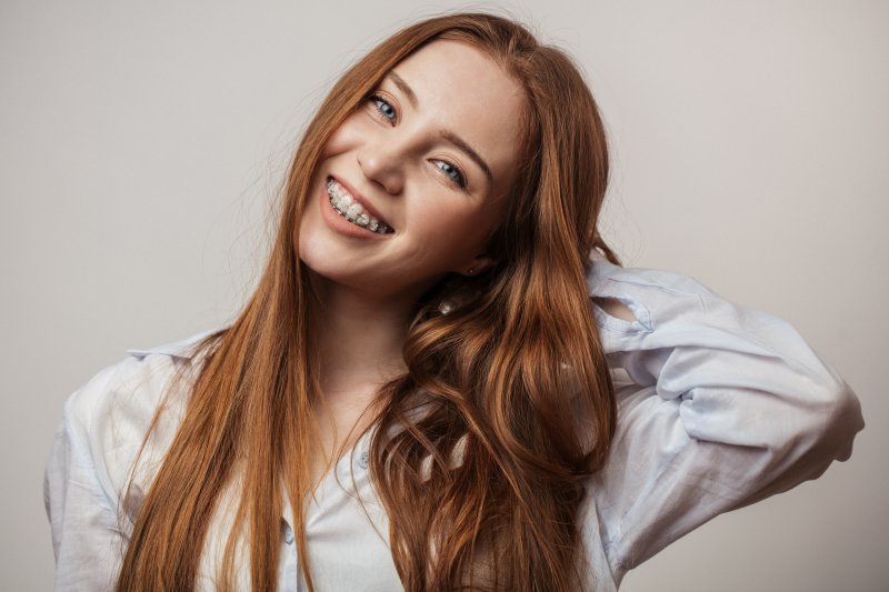 Teen smiles with braces