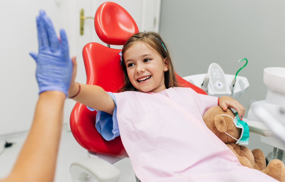 Little girl high fiving dentist