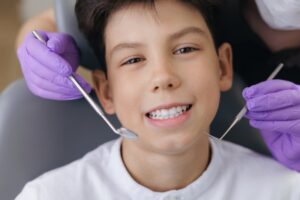 Teen smiling at the pediatric dentist